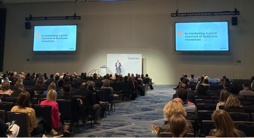 A photo of a speaker and attendees at the Gartner Marketing Symposium/Xpo conference