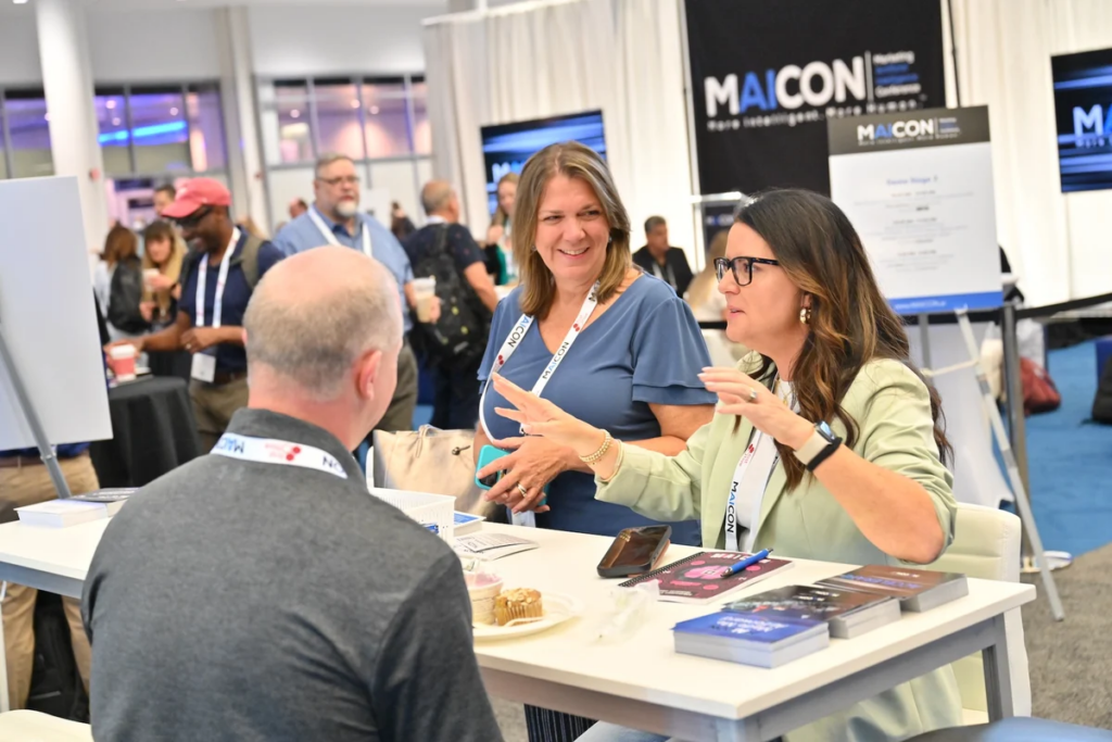Attendees networking at the MAICON