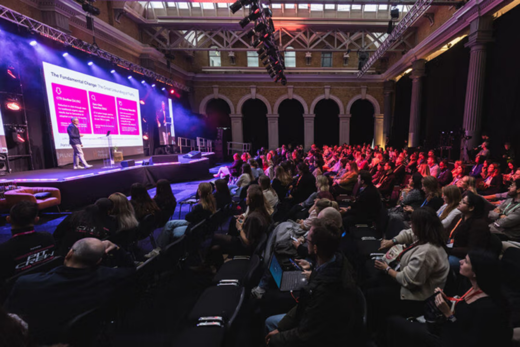 PI Live conference audience attending a keynote session in a large event hall