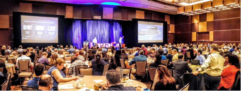 A photo of attendees and speakers at the LavaCon conference session.