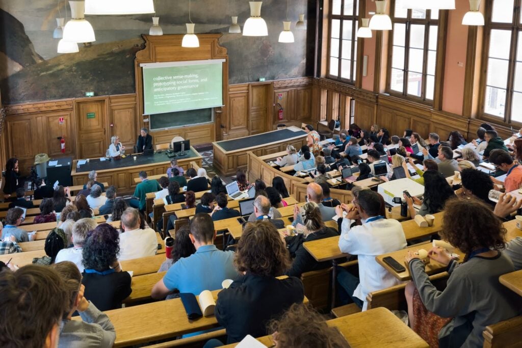 A jampacked lecture hall during a keynote presentation at the International Conference on Communication & Media Studies