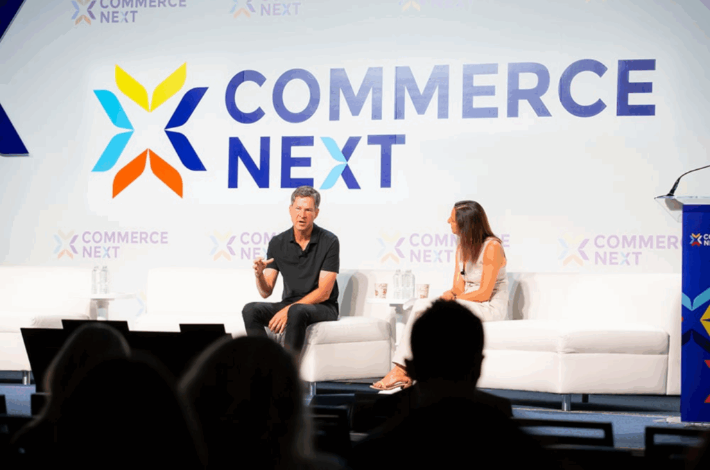 Two speakers engage in a discussion onstage at the CommerceNext Growth Show
