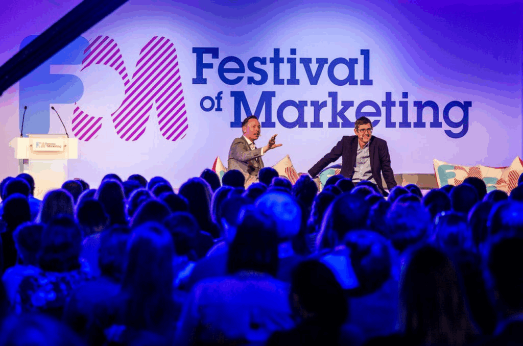 An image of the speakers and attendees at the Festival of Marketing conference