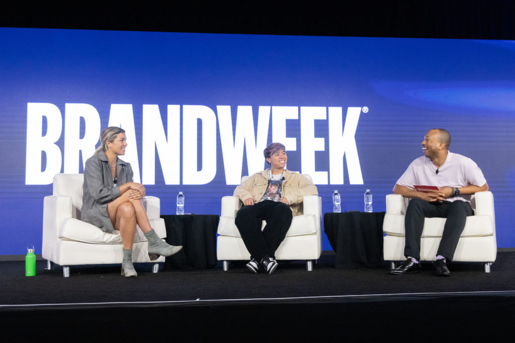 A photo of three speakers sitting on stage at Brandweek during a panel discussion