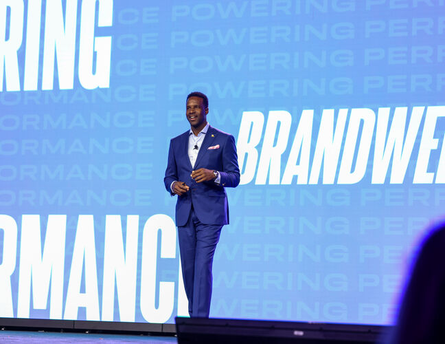 A speaker on stage at the Brandweek Conference.