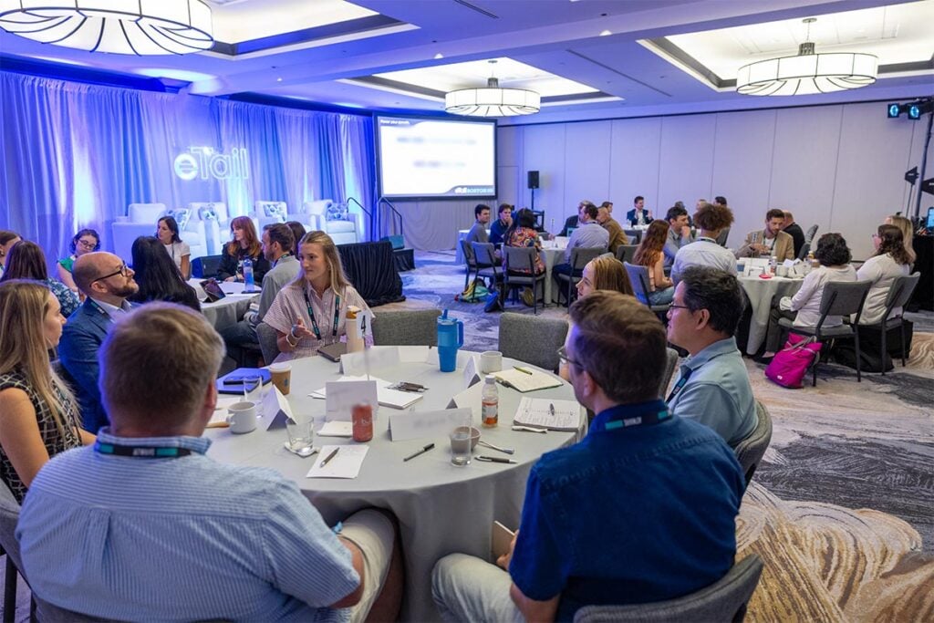 Conference attendees engaged in a networking and discussion session at eTail Boston