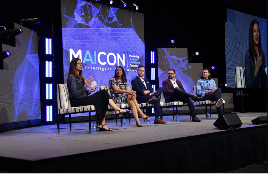 A photo of speakers discussing at the Marketing Artificial Intelligence Conference (MAICON).